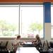 Terry and Gino Pia, of Saline, enjoy breakfast near the windows at Dimo's Deli and Donuts, located at 2030 W Stadium Blvd. Melanie Maxwell | AnnArbor.com